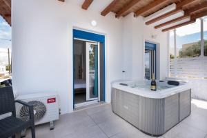 a bathroom with a tub in the middle of a patio at Anzuelo Apartments in Megalochori