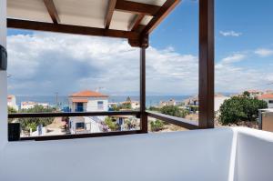 a view of the ocean from a balcony of a house at Anzuelo Apartments in Megalochori