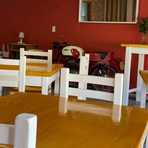 a motorcycle parked in a room with a table and chairs at Hosteria Tobago in Necochea