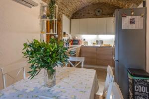 a kitchen with a table with a vase of flowers on it at Casa Angelo in Nerezine