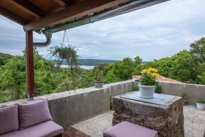 a patio with a couch and a table with a view at Casa Angelo in Nerezine