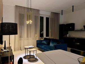 a living room with a blue couch and a table at Rosetta Suite in Novi Vinodolski