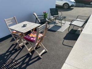 a wooden table and chairs sitting on a patio at Repos paisible in Talmont