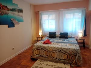 a bedroom with a bed and a large window at AMRoom - Santander in Santander