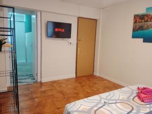 a room with a bed and a tv on the wall at AMRoom - Santander in Santander