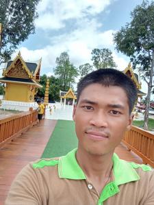 a man standing in front of a temple at โรงเเรม in Ban Kulukhu