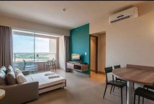 a living room with a couch and a table at Apto completo no Enjoy Solar das águas park resort in Olímpia