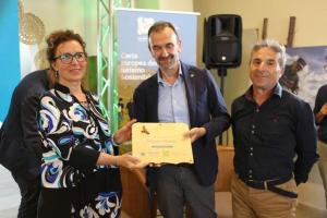 a man is holding a certificate with a woman at B&B Stupor Mundi in Altamura