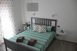 a bedroom with a bed with two bags on it at Appartamento Lungomare Toscanelli in Lido di Ostia