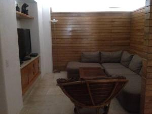 a living room with a couch and a tv at Beautiful beach front apartment in Ixtapa. in Ixtapa