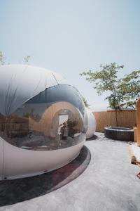 ein rundes Gebäude mit einem großen Fenster auf der Seite in der Unterkunft Fuente del Lobo Glamping & Bungalows - Adults Only in Pinos Genil