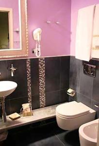 a bathroom with a white toilet and a sink at Locanda A Cà Du Gigante in Monterosso al Mare