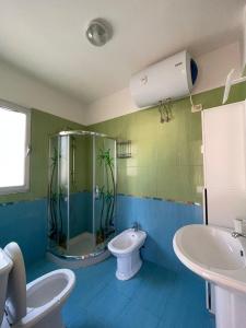 a bathroom with a shower and a toilet and a sink at ANISA Vlore in Vlorë