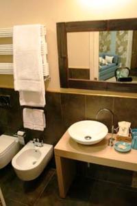 a bathroom with a sink and a toilet and a mirror at Locanda A Cà Du Gigante in Monterosso al Mare
