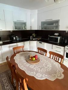 a kitchen with a table with a bowl of fruit on it at Villa Zak in Blagaj