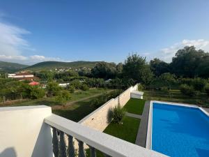 a swimming pool on the balcony of a house at Villa Zak in Blagaj