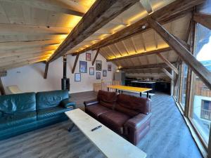 a living room with a couch and a table at Chalet Des Legendes in La Combe