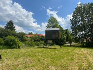 a sign in the grass in a field at Posedy Panský dvůr Telč in Telč