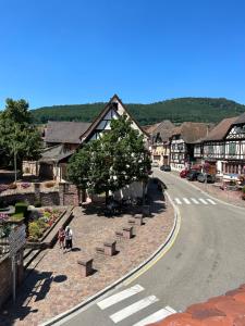 a street in a small town with people walking down the street at GITE MA MAISON in Kintzheim