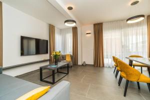 een woonkamer met een bank en een tafel bij Villa Petra 1 - private pool in Novalja