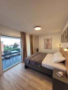 een slaapkamer met een groot bed en een groot raam bij Villa Petra 1 - private pool in Novalja +21 foto's