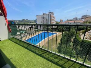 a balcony with a view of a swimming pool at NICE APARTAMEN in Lloret de Mar