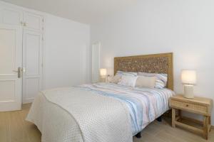a bedroom with a bed and two lamps on a table at La Luz de la Luna in Costa Teguise +22 photos