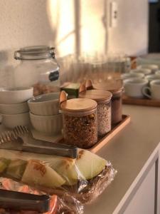 a counter with jars of food on a counter top at Pousada Flor De Brasília in Brasilia