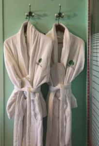 a robe hanging on a mirror in a bathroom at Vaela Hotel Cultural Resort in Elatochori