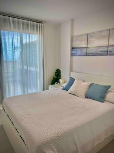 a bedroom with a large bed with a window at Rincón Idilia (Málaga). in Rincón de la Victoria +73 photos