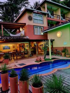 a house with a swimming pool in front of it at Pousada Bahia Bella in Morro de São Paulo