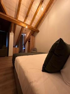 a bedroom with a bed with a pillow on it at Hotel Le Postillon in Echternach