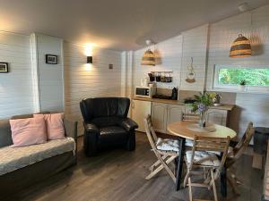 a living room with a couch and a table and a chair at Vecliepas in Vārve