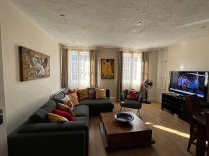 a living room with a couch and a tv at Stay in Yeovil Town Centre, Large 2 BD Apt With Parking, Sleeps 4 in Yeovil