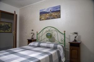 a bedroom with a bed with a plaidkered blanket at L'Alpino in Sulmona