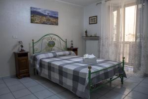 - une chambre avec un lit et une couverture en damier dans l'établissement L'Alpino, à Sulmona