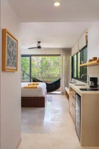 a kitchen and a bedroom with a bed and a sink at Ave Del Paraíso PH - 3-Bedrooms and a Pool in Tulum