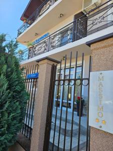 a sign on a gate in front of a building at Vila Massimo in Eforie Nord +37 photos