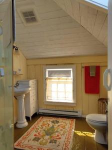 a bathroom with a sink and a toilet and a window at Dory Buff House in Princeton