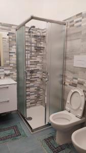 a bathroom with a shower with a toilet and a sink at Casamare in Torre Forte