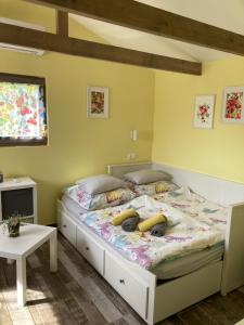 1 dormitorio con 1 cama grande y paredes amarillas en NEUTRINO VENDÉGHÁZ, en Zánka