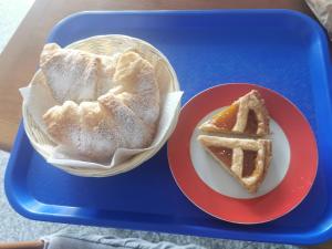 a tray with a plate of bread and a slice of pie at Astra in Agerola