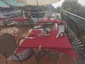a table with a red table cloth on a balcony at Astra in Agerola