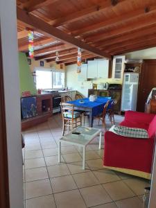 a kitchen and dining room with a blue table and chairs at Casa intera indipendente con giardino privato in Imperia