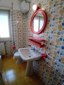 a bathroom with a sink and a mirror on the wall at Casa dei miei in Sperlonga