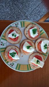 a plate of sandwiches with cheese and tomatoes on it at Astra in Agerola