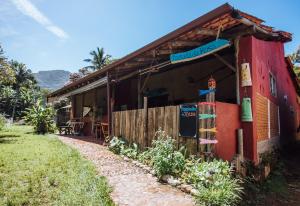 a small red building with a sign on it at Pousada da Rosa in Ilhabela