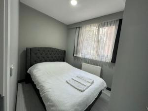 a small bedroom with a bed and a window at Rose Plus Residence in Istanbul