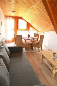 a living room with a couch and chairs and a table at Vidéki Ház in Tagyon