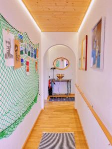 a hallway with a wall with pictures on it at Großzügige Wohnung, Bergblick, Vintage in Sonthofen